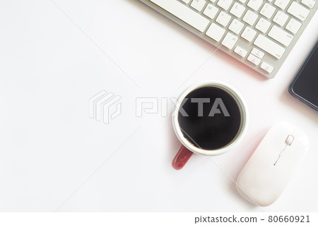 White desk office with laptop, smartphone and other work supplies with cup of coffee. Top view with copy space for input the text. Designer workspace on desk table essential elements on flat lay. 80660921