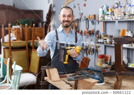 Craftsman repairing antique furniture Craftsman repairing antique furniture 80661122
