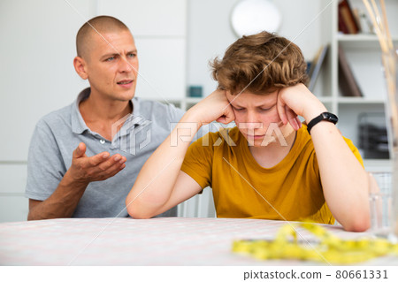 Son feeling sad and father talking to him Son feeling sad and father talking to him 80661331
