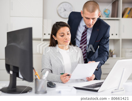 Businessman and business woman working together at office Businessman and business woman working together at office 80661421