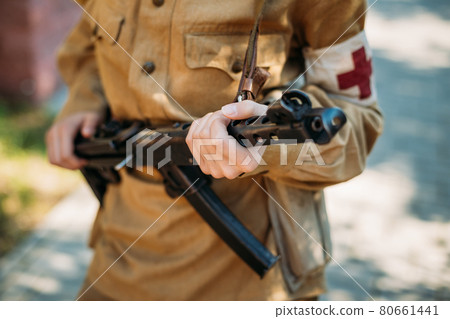 Unidentified reconstructor dressed as a Soviet military nurse with a submachine gun in hand 80661441
