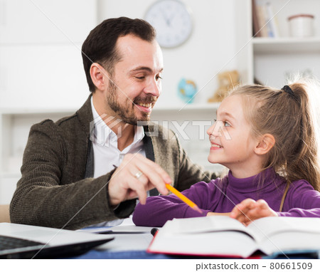 Father helping daughter with homework Father helping daughter with homework 80661509