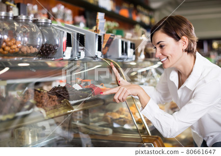 Woman choosing dessert Woman choosing dessert 80661647