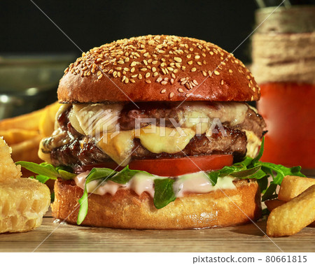 Burger with two patties, cheese, tomatoes and greens in sesame bun 80661815