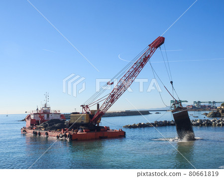 Grab Dredge with Clamshell Bucket unloading gravel to replenish beach 80661819