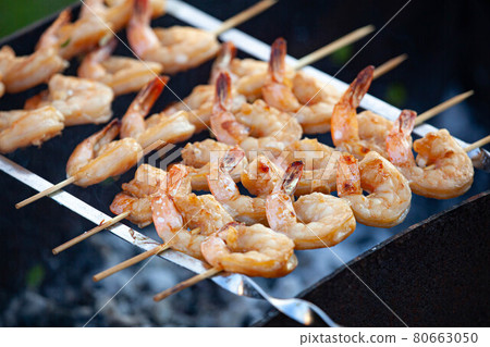 Shrimp grilling over an open flame Shrimp grilling over an open flame 80663050