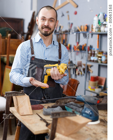 Craftsman repairing antique furniture Craftsman repairing antique furniture 80663168