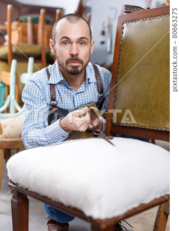 Craftsman using carpentry tools for restoration Craftsman using carpentry tools for restoration 80663275