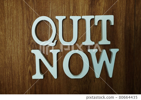 Quit Now word alphabet letters on wooden background Quit Now word alphabet letters on wooden background 80664435