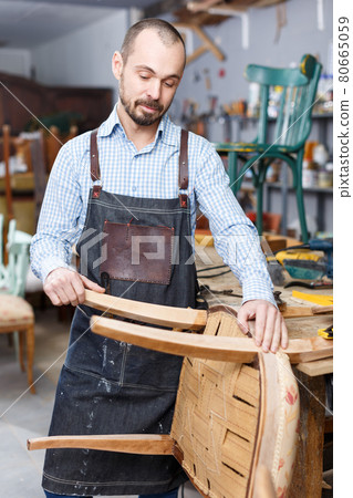Carpenter repairing antique chair Carpenter repairing antique chair 80665059