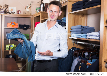 Customer examining trousers Customer examining trousers 80665128