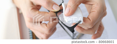 Woman wipes glasses of her glasses with cleaning napkin 80668601