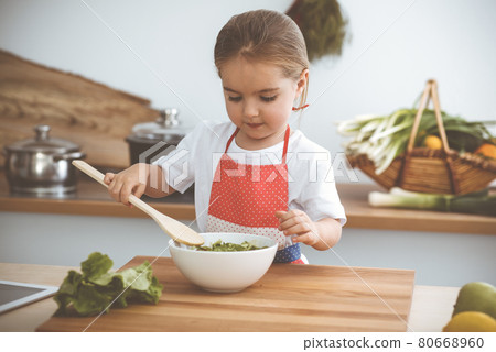 Happy woman and her daughter making healthy vegan salad and snacks for family feasting. Christmas, New year, Thanksgiving, Anniversary, Mothers Day. Healthy meal cooking concept Happy woman and her daughter making healthy vegan salad and snacks for family feasting. Christmas, New year, Thanksgiving, Anniversary, Mothers Day. Healthy meal cooking concept 80668960