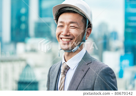 A businessman wearing a helmet A businessman wearing a helmet 80670142