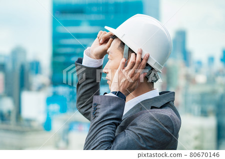 A businessman wearing a helmet A businessman wearing a helmet 80670146