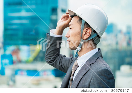 A businessman wearing a helmet A businessman wearing a helmet 80670147