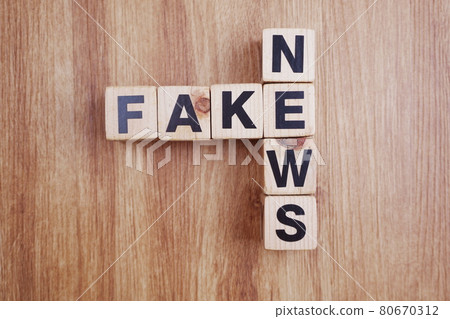 Fake News word alphabet letters on wooden background 80670312