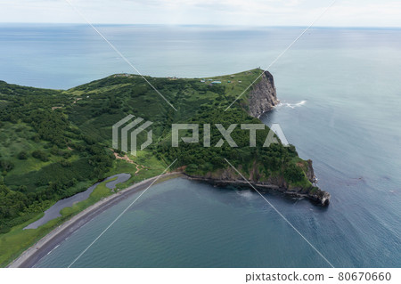 Aerial drone photo of Mayachny Cape on Kamchatka Peninsula on picturesque Avacha bay coast covered by green grass in the Pacific Ocean 80670660