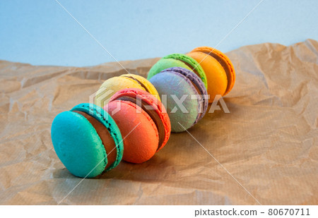 Multicolored macarons with wrapping craft paper. 80670711