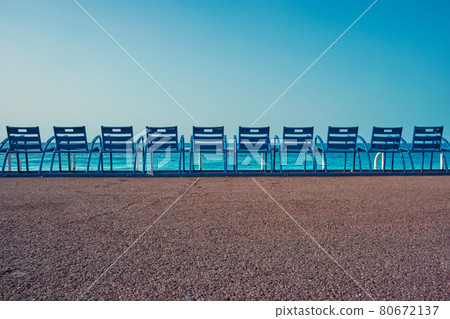 Famous blue chairs on beach of Nice, France Famous blue chairs on beach of Nice, France 80672137