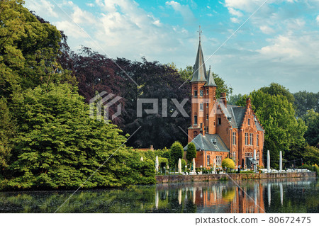 Kasteel Minnewater restaurant on Minnewater lake in Bruges, Belgium 80672475