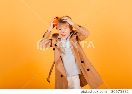 Shocked boy holding clock alarm, copy space. Kid isolated over yellow background. Time for school. Shocked boy holding clock alarm, copy space. Kid isolated over yellow background. Time for school. 80675881