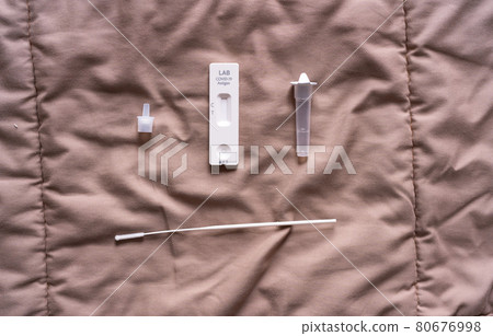 A set of COVID-19 rapid self test kits with medical equipment isolated on bed at home. Antigen or Antibody test. Virus disease healthcare check. A set of COVID-19 rapid self test kits with medical equipment isolated on bed at home. Antigen or Antibody test. Virus disease healthcare check. 80676998