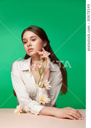 Young woman with flowers in blouse sleeves Young woman with flowers in blouse sleeves 80678549