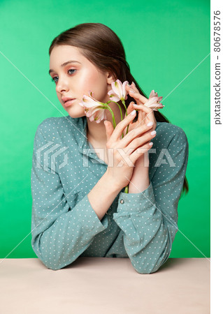 Young woman with flowers in blouse sleeves 80678576