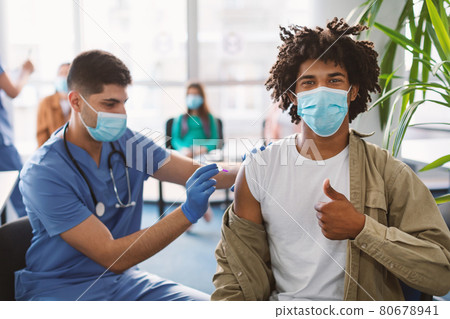 Black Guy In Mask Receiving Coronavirus Vaccine Injection In Clinic 80678941