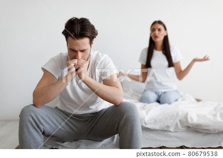 Discontented Wife Blaming Unhappy Husband Having Quarrel In Bedroom 80679538
