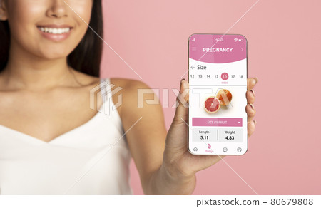 Young pregnant woman using mobile app for pregnancy Young pregnant woman using mobile app for pregnancy 80679808