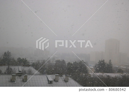 Heavy snowfall outside the window. Global climate change, environmental problems. 80680342