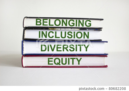 Belonging symbol. Books with words 'belonging, inclusion, diversity equity' on beautiful white table, white background. Business, belonging, diversity and inclusion concept. Copy space. Belonging symbol. Books with words 'belonging, inclusion, diversity equity' on beautiful white table, white background. Business, belonging, diversity and inclusion concept. Copy space. 80682208