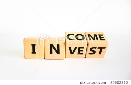 Invest or income symbol. Turned wooden cubes and changed the word 'invest' to 'income'. Beautiful white background, copy space. Business and invest or income concept. 80682210