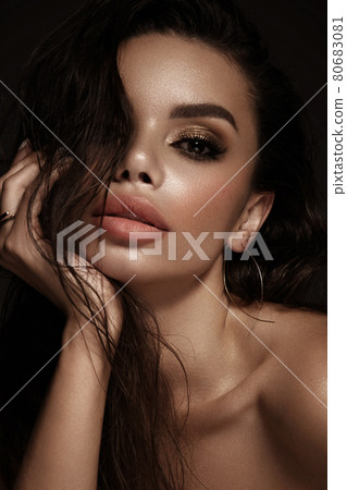 Beautiful girl with bright fashionable make-up and unusual gold accessories. Beauty face. 80683081