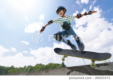 Boy jumping on a skateboard 80683472