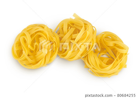 Raw tagliatelle pasta isolated on white background with clipping path and full depth of field. Top view. Flat lay Raw tagliatelle pasta isolated on white background with clipping path and full depth of field. Top view. Flat lay 80684255