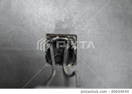 Repair or installation of a new light switch in the wall. Light switch connected via cables to a electricity in a home. 80684649