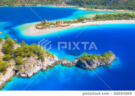 Aerial view of sea bay, rock, sandy beach, trees, mountain 80684869