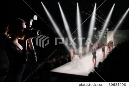 Photographer Press Woman use Camera to shoots Photo of Fashion Week Show which Model Supermodel walk on Runway Catwalk for New collection of designer brand, background copy space 80685908