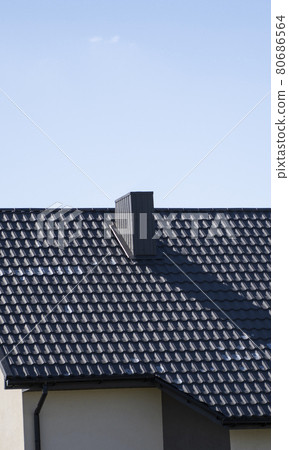 Brown corrugated metal profile roof installed on a modern house. The roof of corrugated sheet. Roofing of metal profile wavy shape. Modern roof made of metal. Metal roofing. 80686564