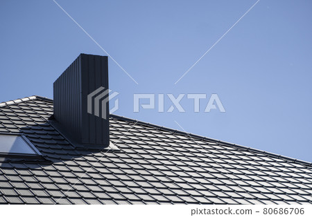 Brown corrugated metal profile roof installed on a modern house. The roof of corrugated sheet. Roofing of metal profile wavy shape. Modern roof made of metal. Metal roofing. Brown corrugated metal profile roof installed on a modern house. The roof of corrugated sheet. Roofing of metal profile wavy shape. Modern roof made of metal. Metal roofing. 80686706
