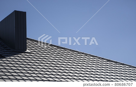 Brown corrugated metal profile roof installed on a modern house. The roof of corrugated sheet. Roofing of metal profile wavy shape. Modern roof made of metal. Metal roofing. Brown corrugated metal profile roof installed on a modern house. The roof of corrugated sheet. Roofing of metal profile wavy shape. Modern roof made of metal. Metal roofing. 80686707