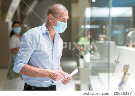 man with mask in museum 80688327