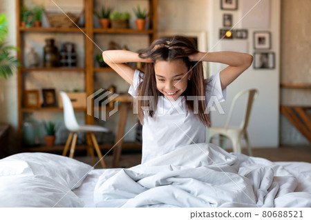 Photo of a girl woke up and stretching. 80688521