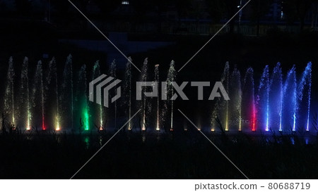 A fountain lit up by the night stream A fountain lit up by the night stream 80688719