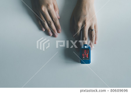 Patient women using fingertip pulse oximeter oxygen saturation meter SPO2 PR blood monitor finger on white background 80689696
