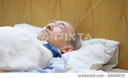 Senior man sleeping in bed Senior man sleeping in bed 80689830