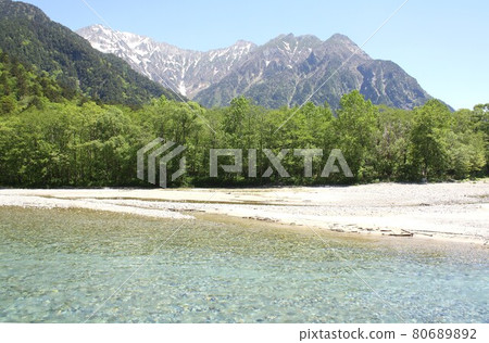 Shinshu Kamikochi, Azusa River surrounded by fresh spring greenery, Hotaka mountain range and Mt. Myojindake in the background Shinshu Kamikochi, Azusa River surrounded by fresh spring greenery, Hotaka mountain range and Mt. Myojindake in the background 80689892